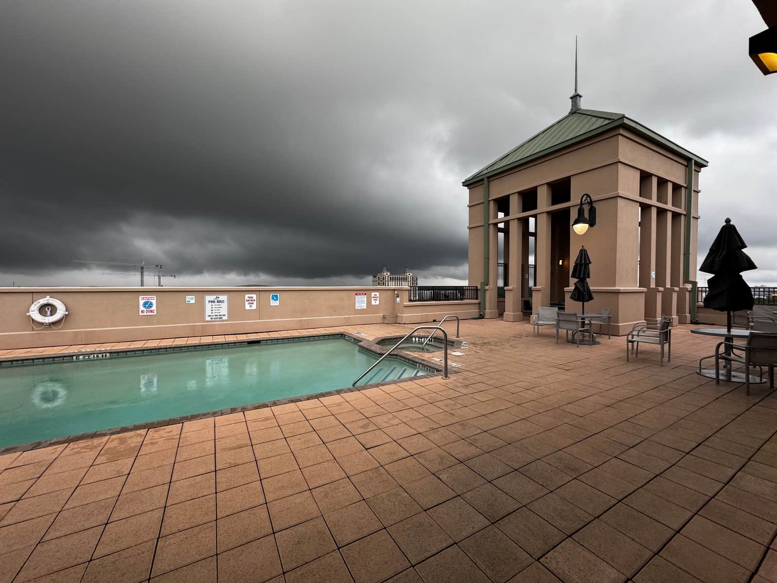 Heavy rain falling onto the surface of a swimming pool