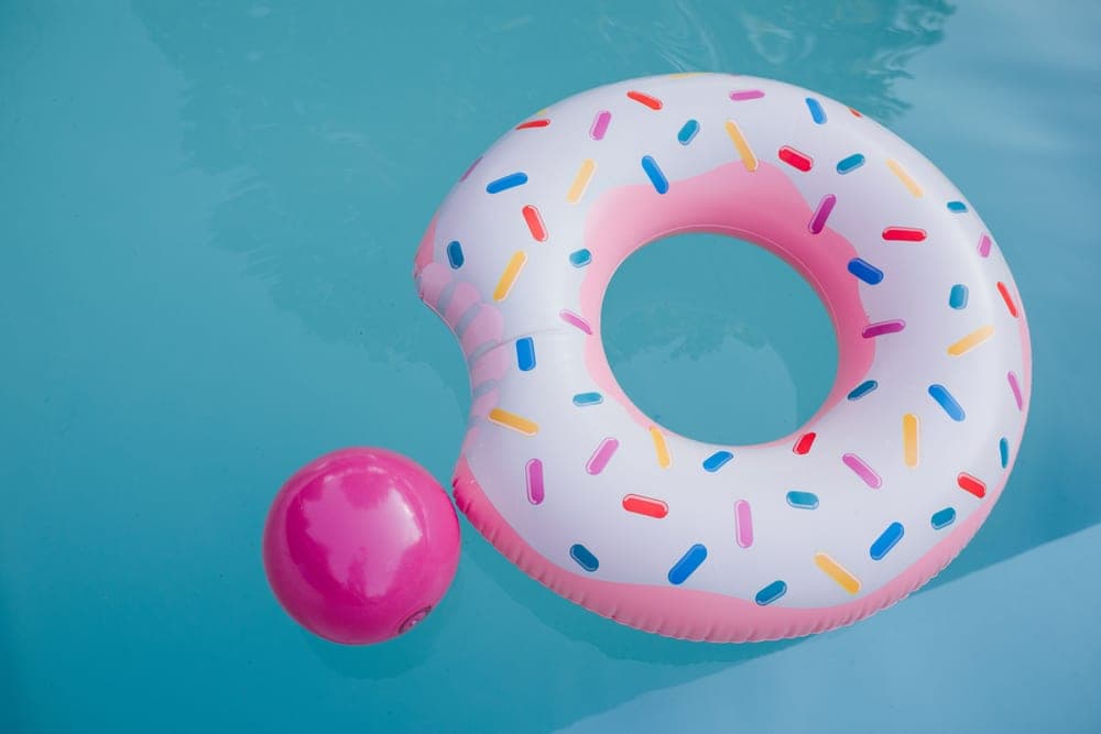 An inflatable swimming pool filled with water in a garden