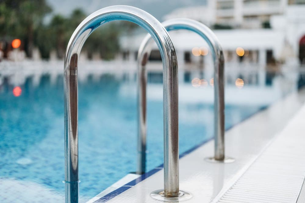 A metal ladder leading into a swimming pool