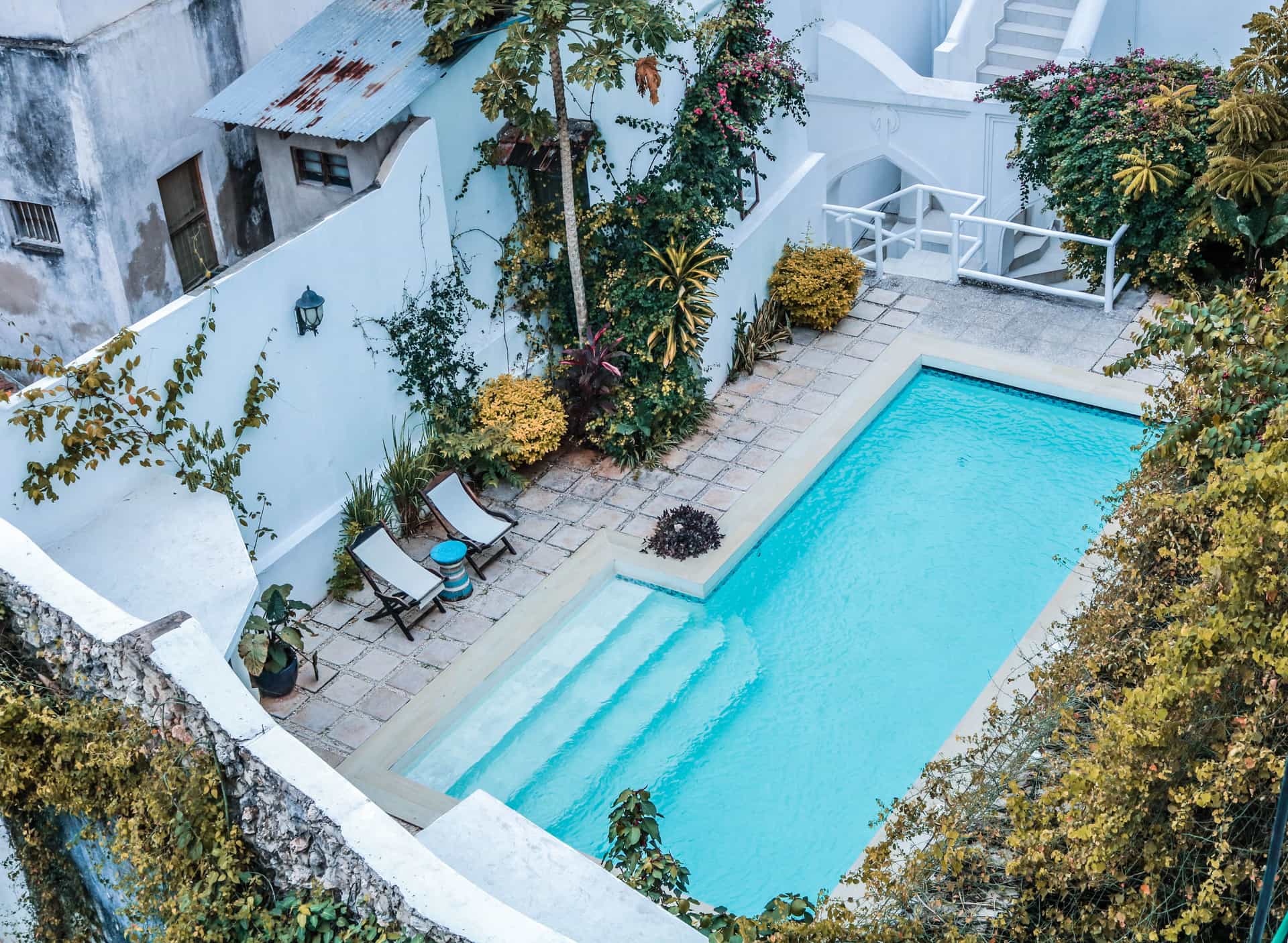 A pool set into a terraced garden with retaining walls