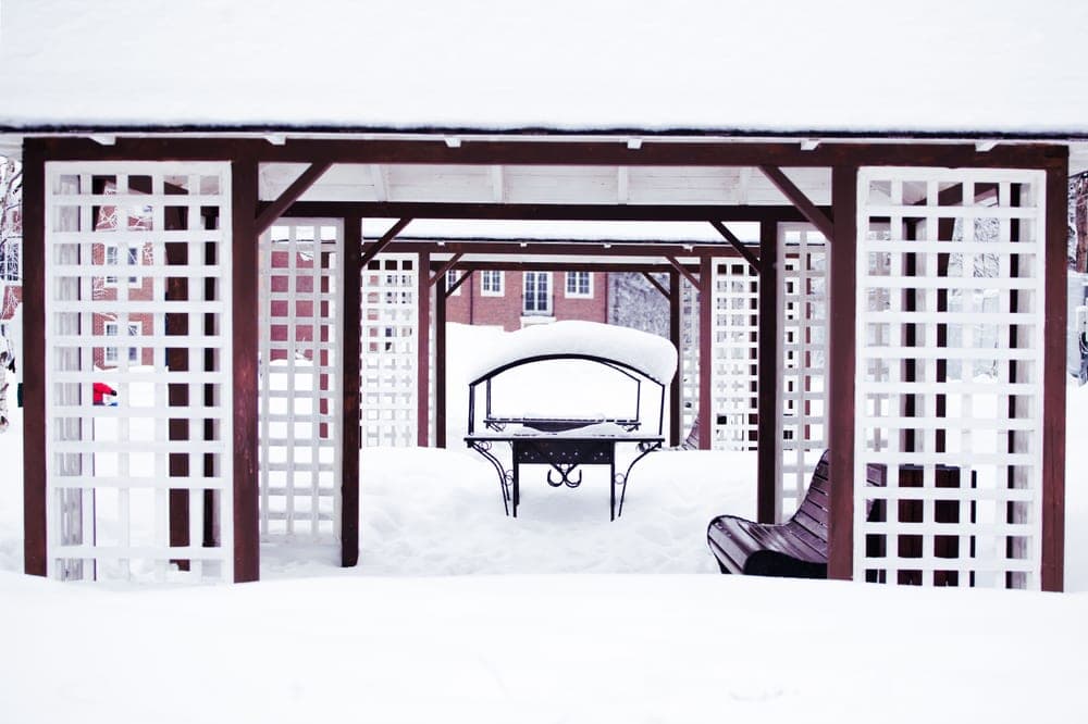 Outdoor furniture being covered and packed away for winter