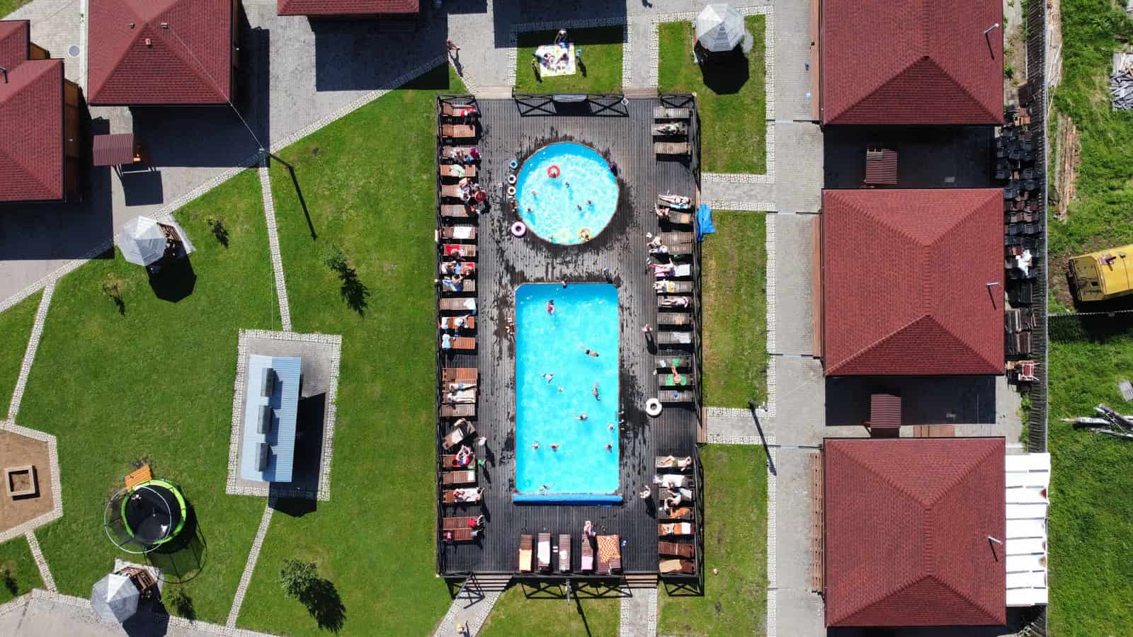 An aerial view of gardens with swimming pools of different sizes