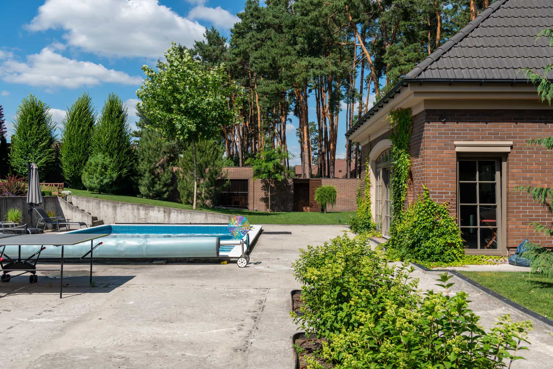 A backyard swimming pool beside a suburban house