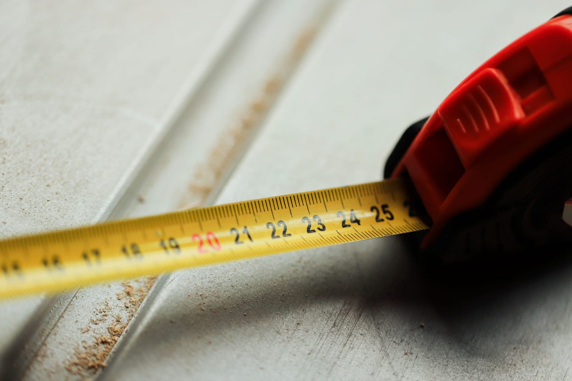 A tape measure laid across a work surface