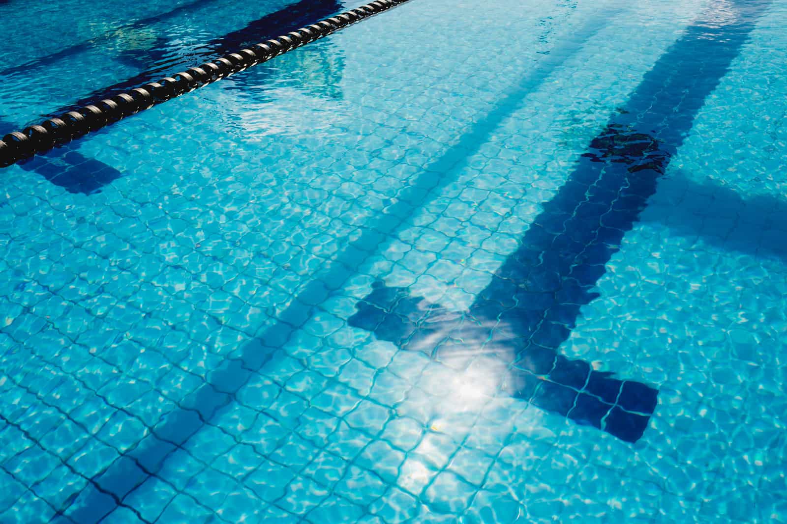 Bright sunlight reflecting off the surface of swimming pool water