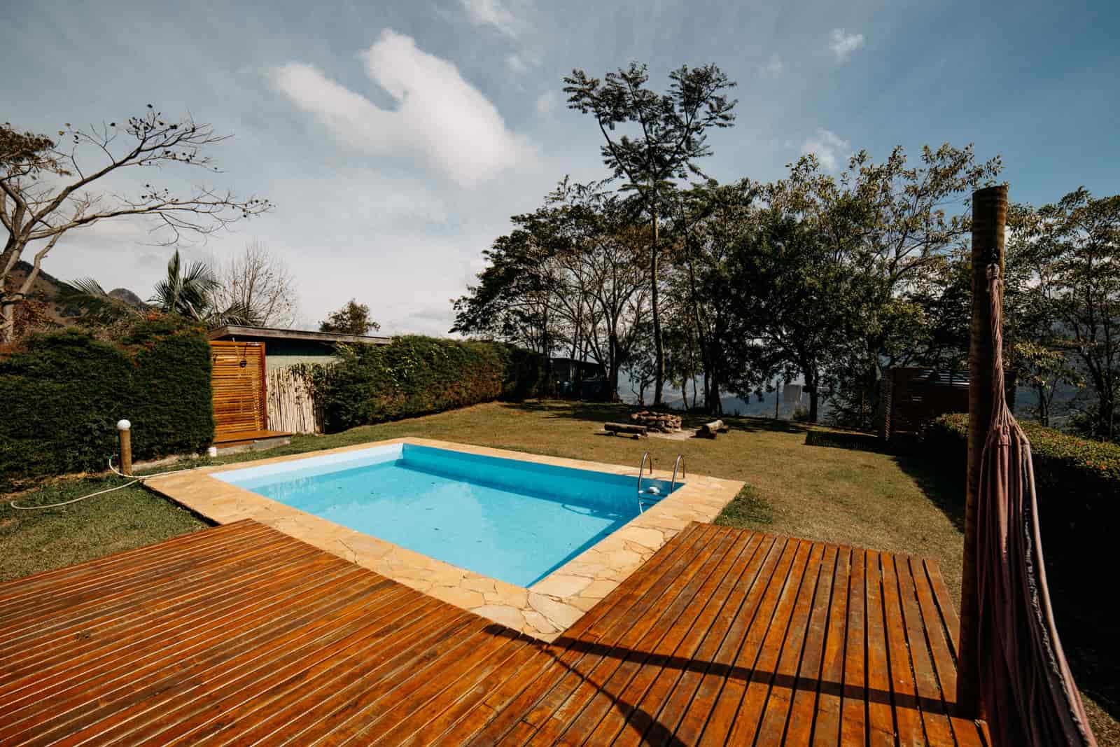 A wooden deck built alongside a swimming pool