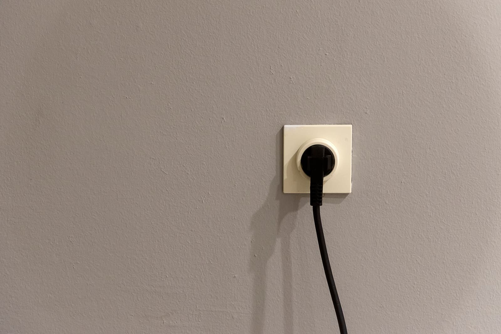 An outdoor electrical socket mounted on an exterior wall