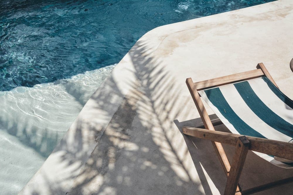 A sun lounger beside a swimming pool