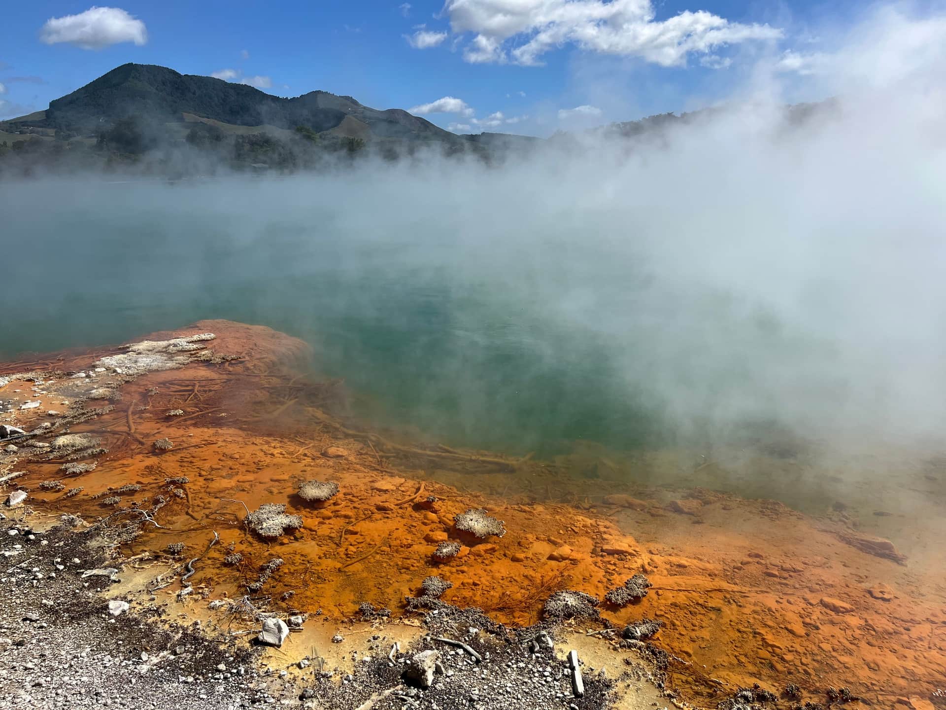 Steam rising from a natural geothermal pool