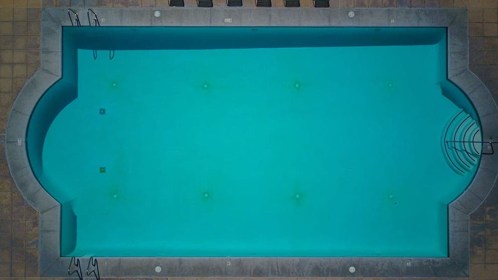 A round above-ground pool filled with blue water