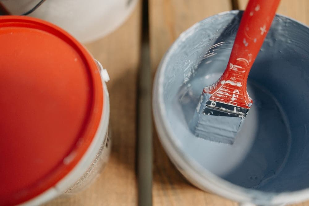 A bucket of cleaning supplies and a brush