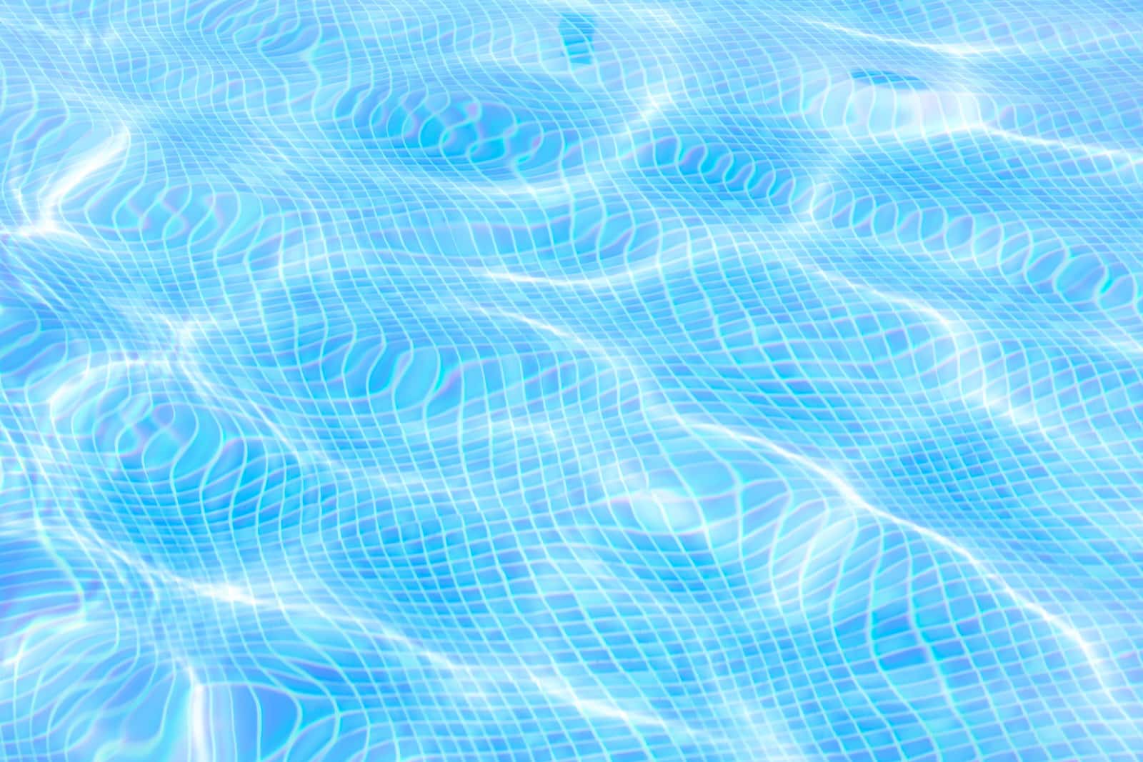 A clean swimming pool with clear blue water in bright summer sun