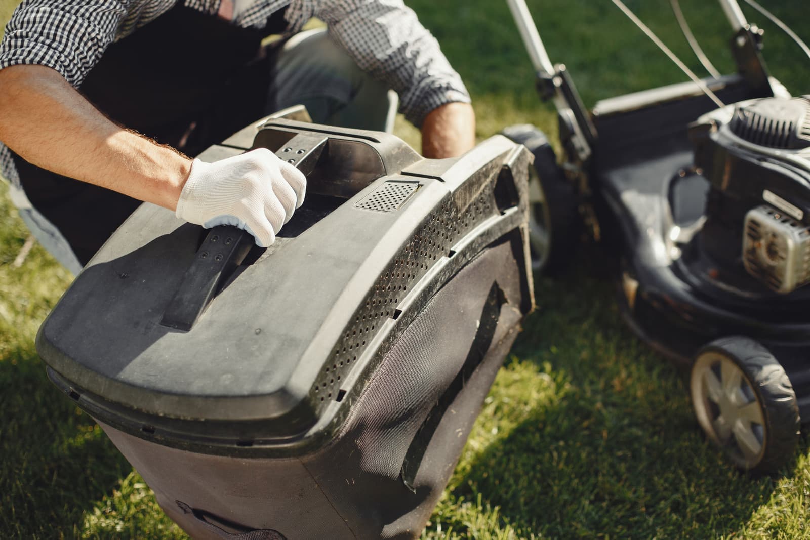 Garden machinery being handled on a lawn