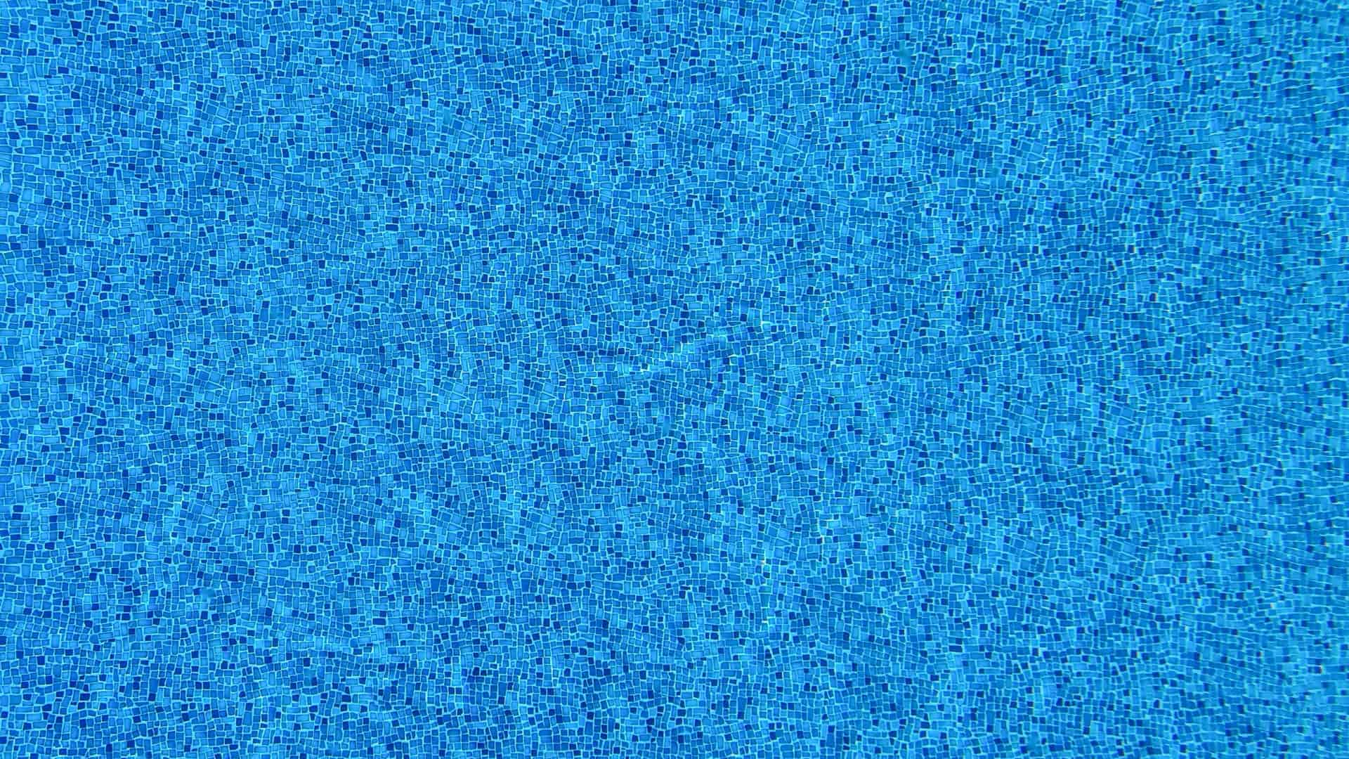 Blue mosaic tiles lining a swimming pool