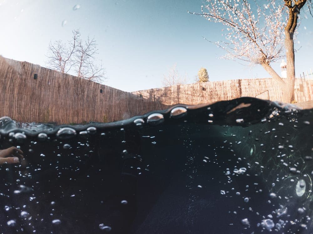 A swimming pool being opened in spring sunshine