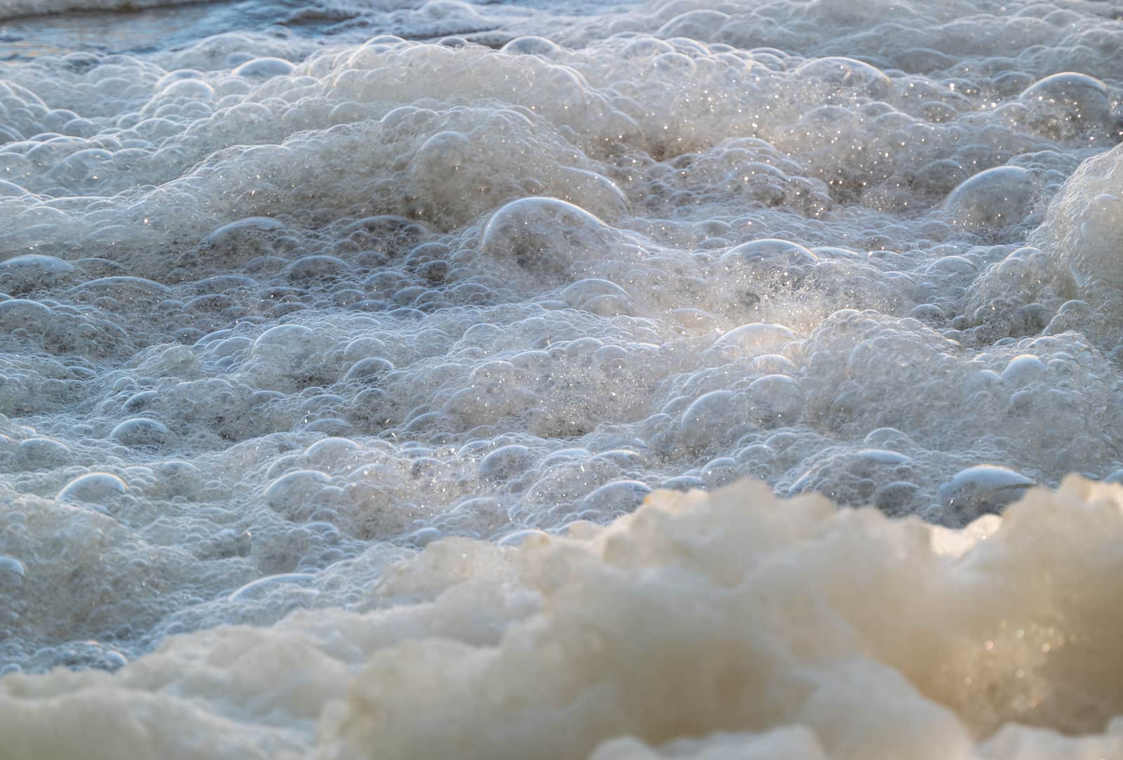 Foam and bubbles on the surface of water