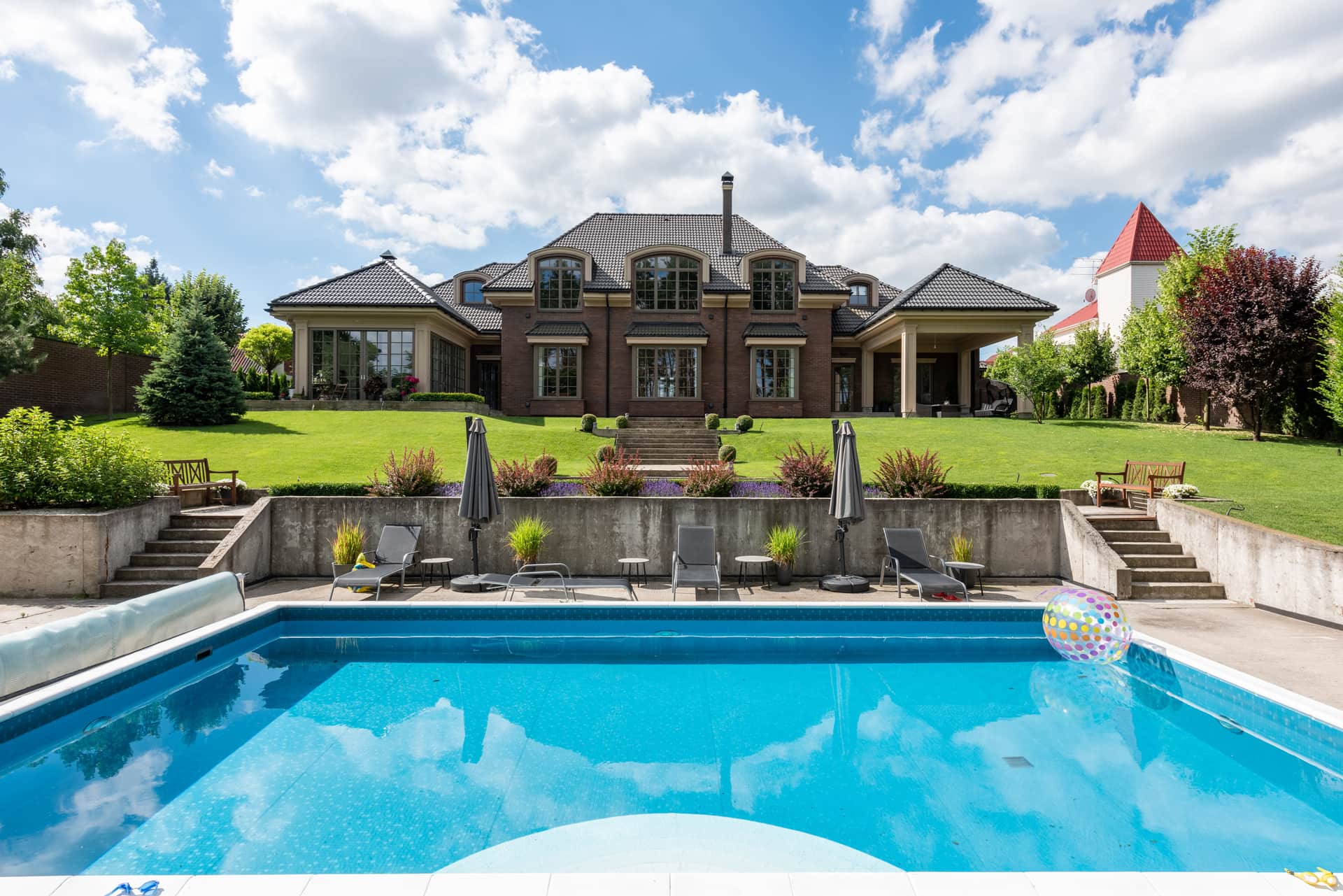 A large house with a swimming pool and garden