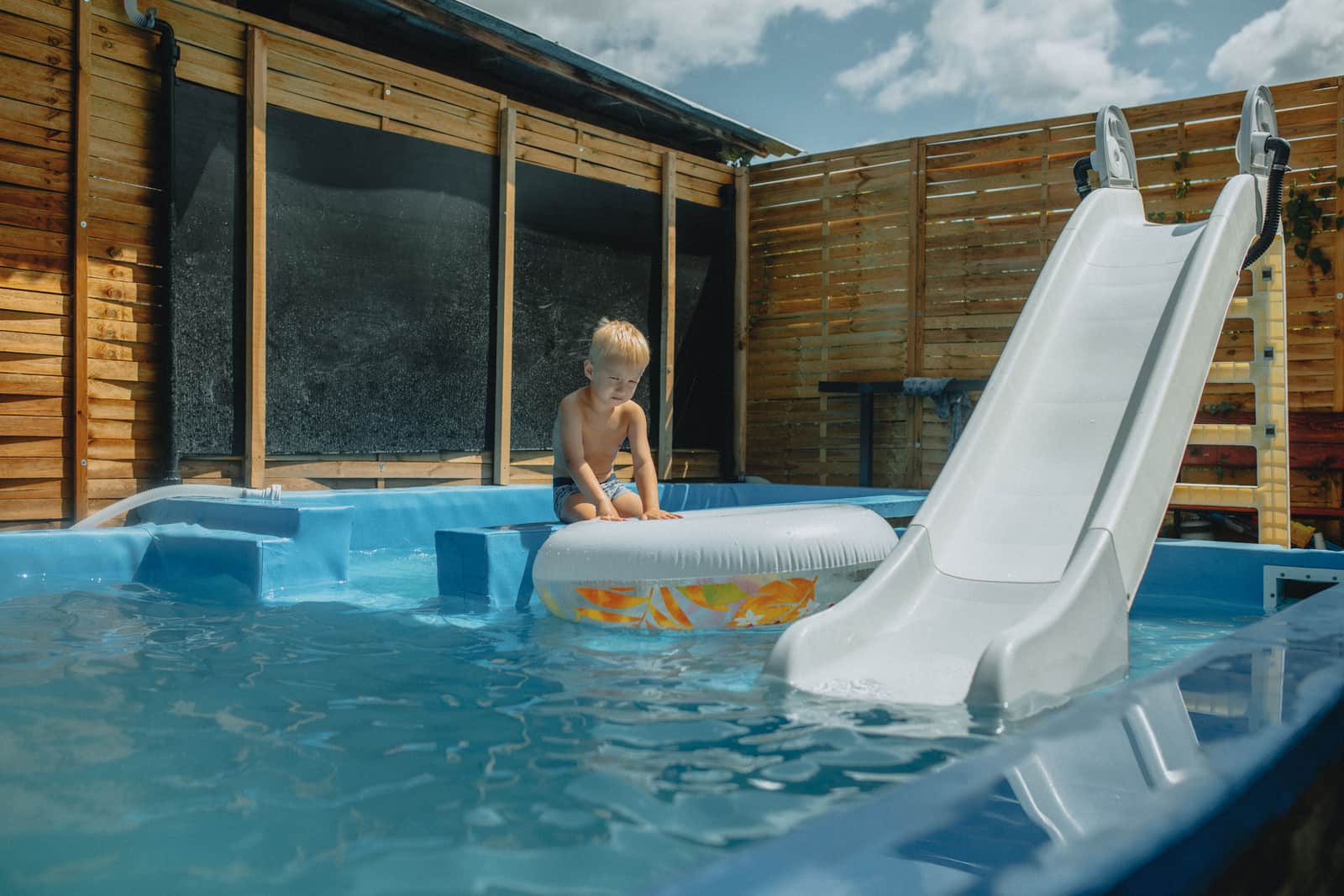 A weathered backyard swimming pool at the end of the season
