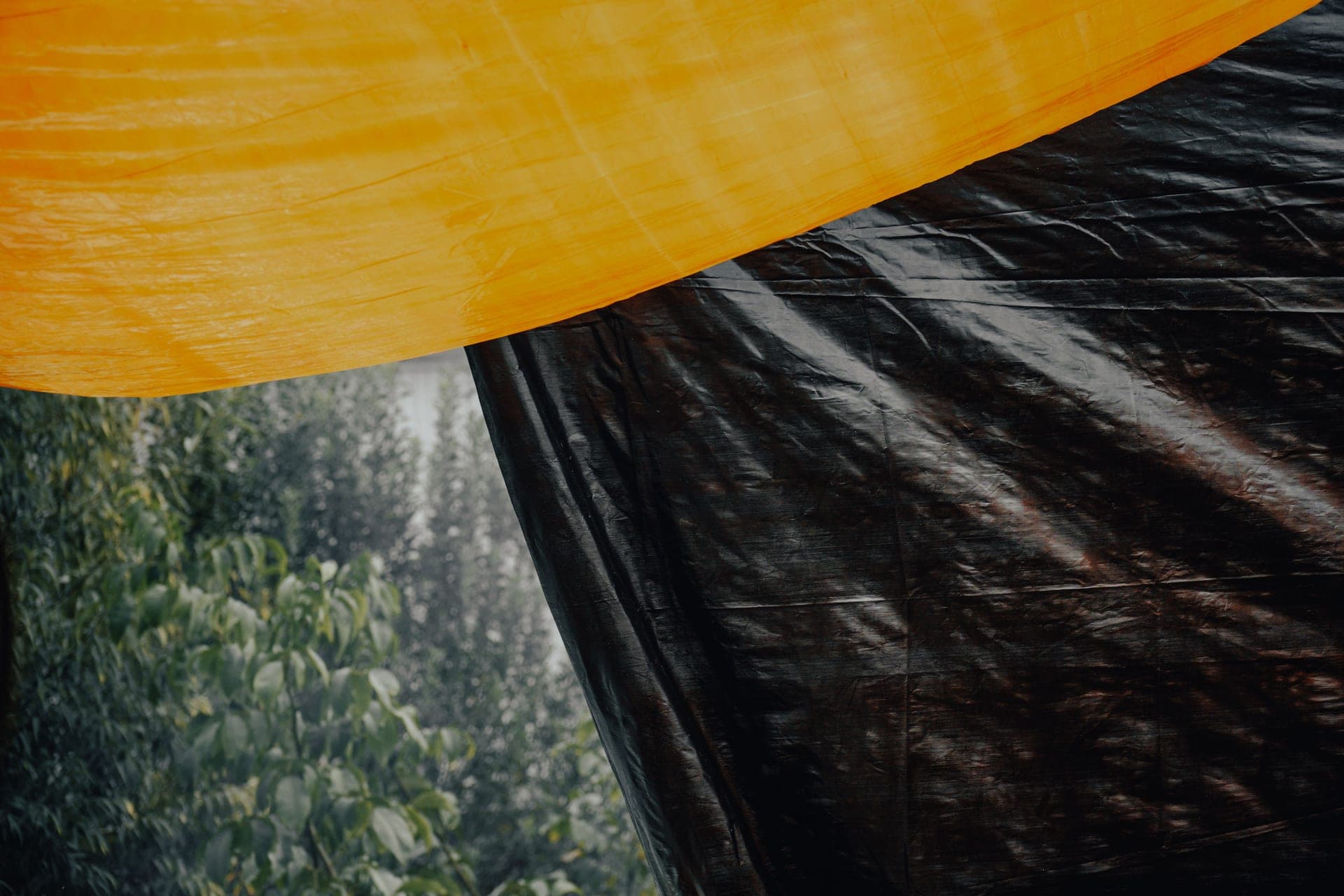 A close-up of orange and black tarpaulin sheeting