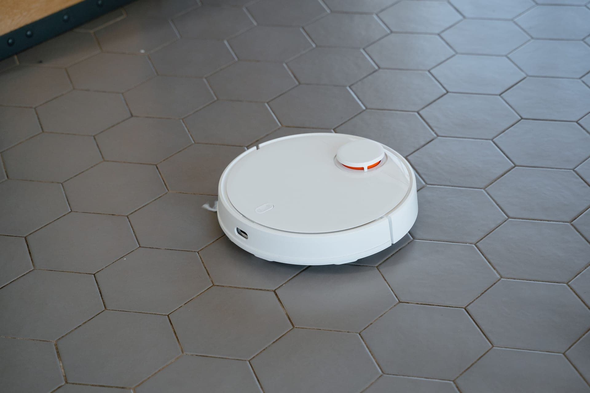 A robotic vacuum cleaner on a tiled floor