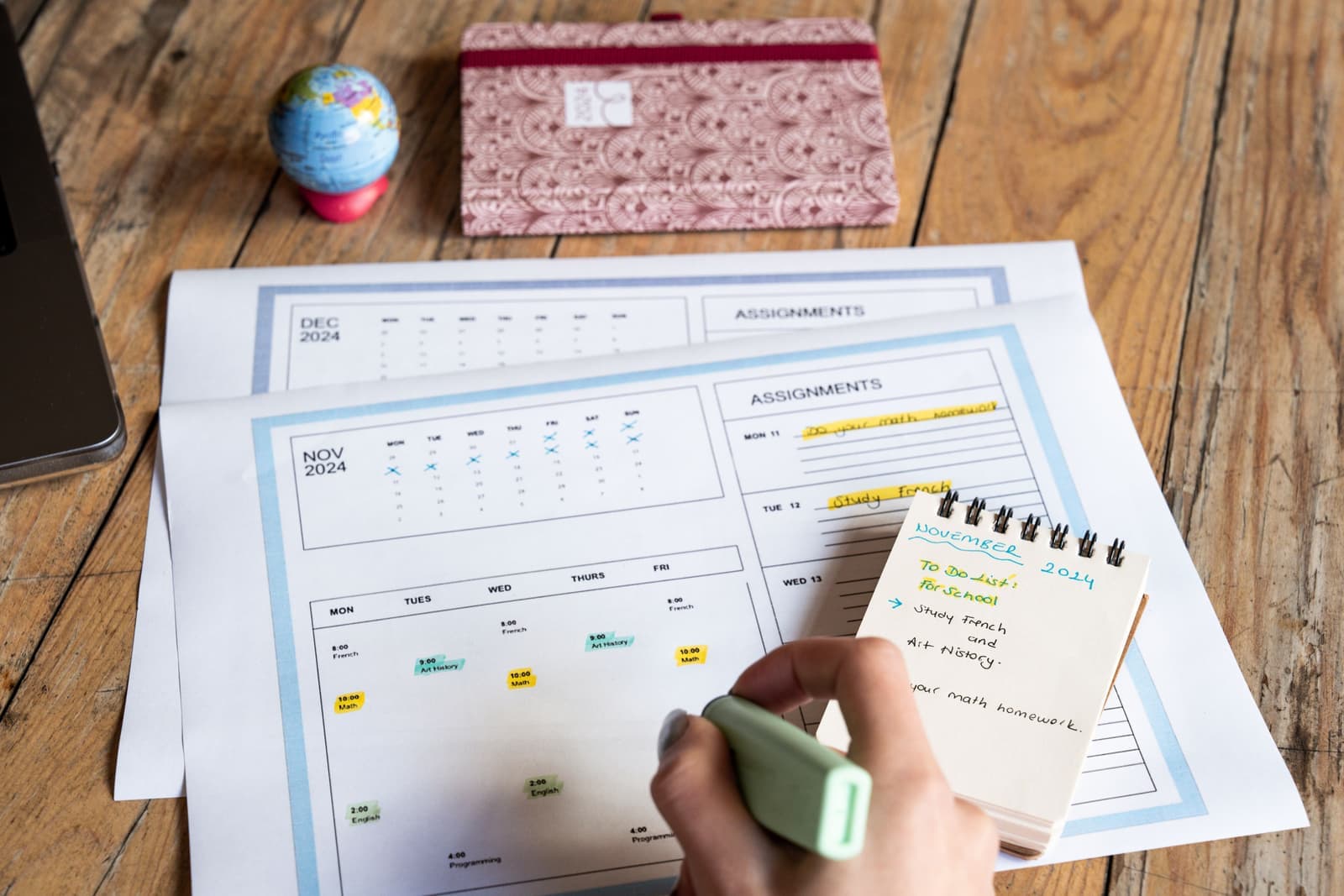 A paper calendar and planner open on a desk