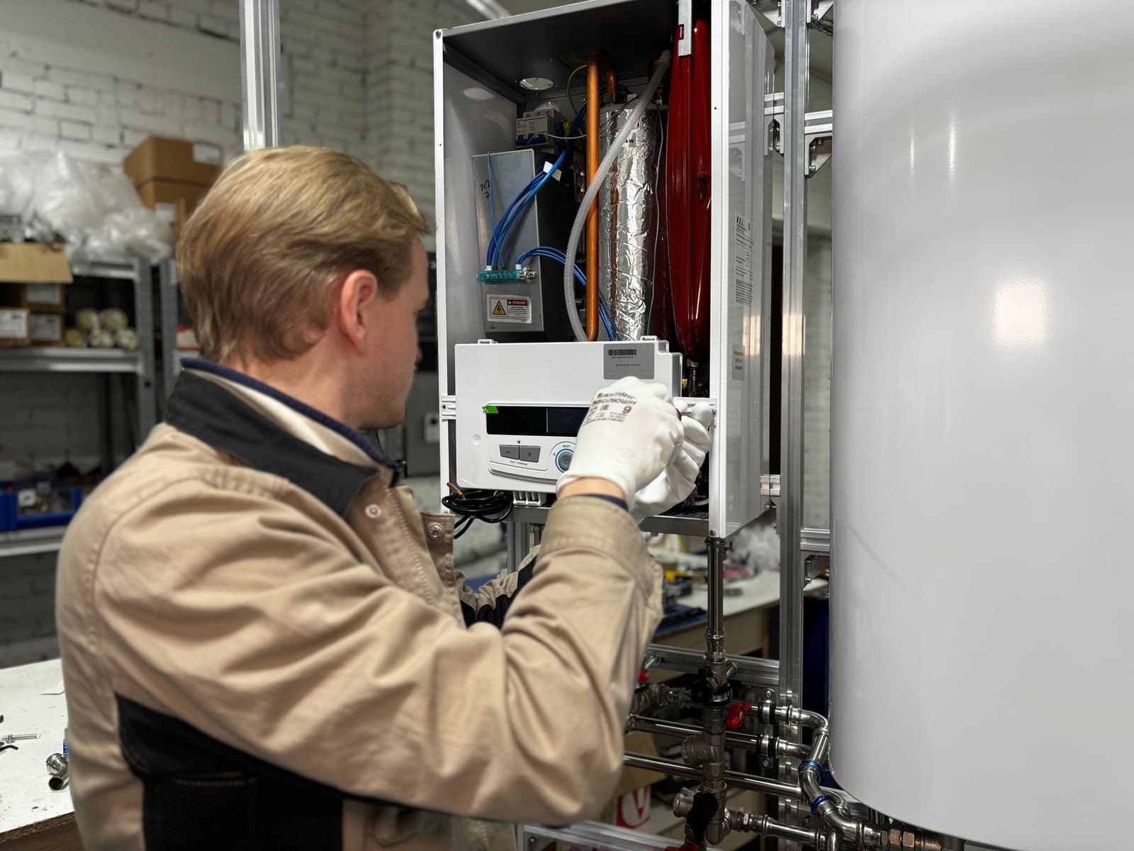 A technician working on a water heating unit