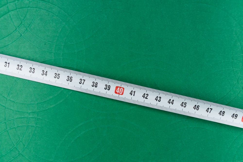 A tape measure lying on a green lawn