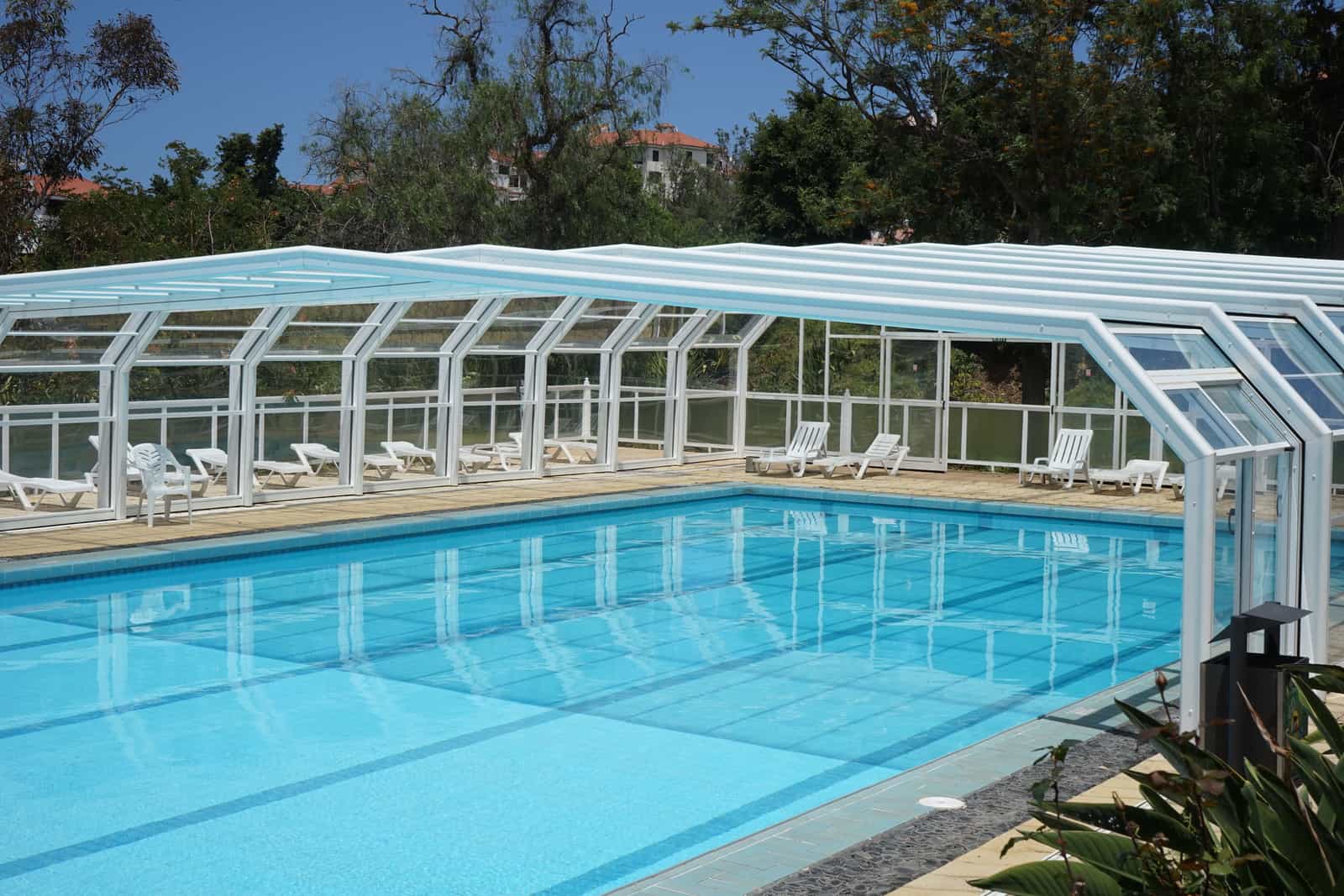 A swimming pool with a cover pulled across the water