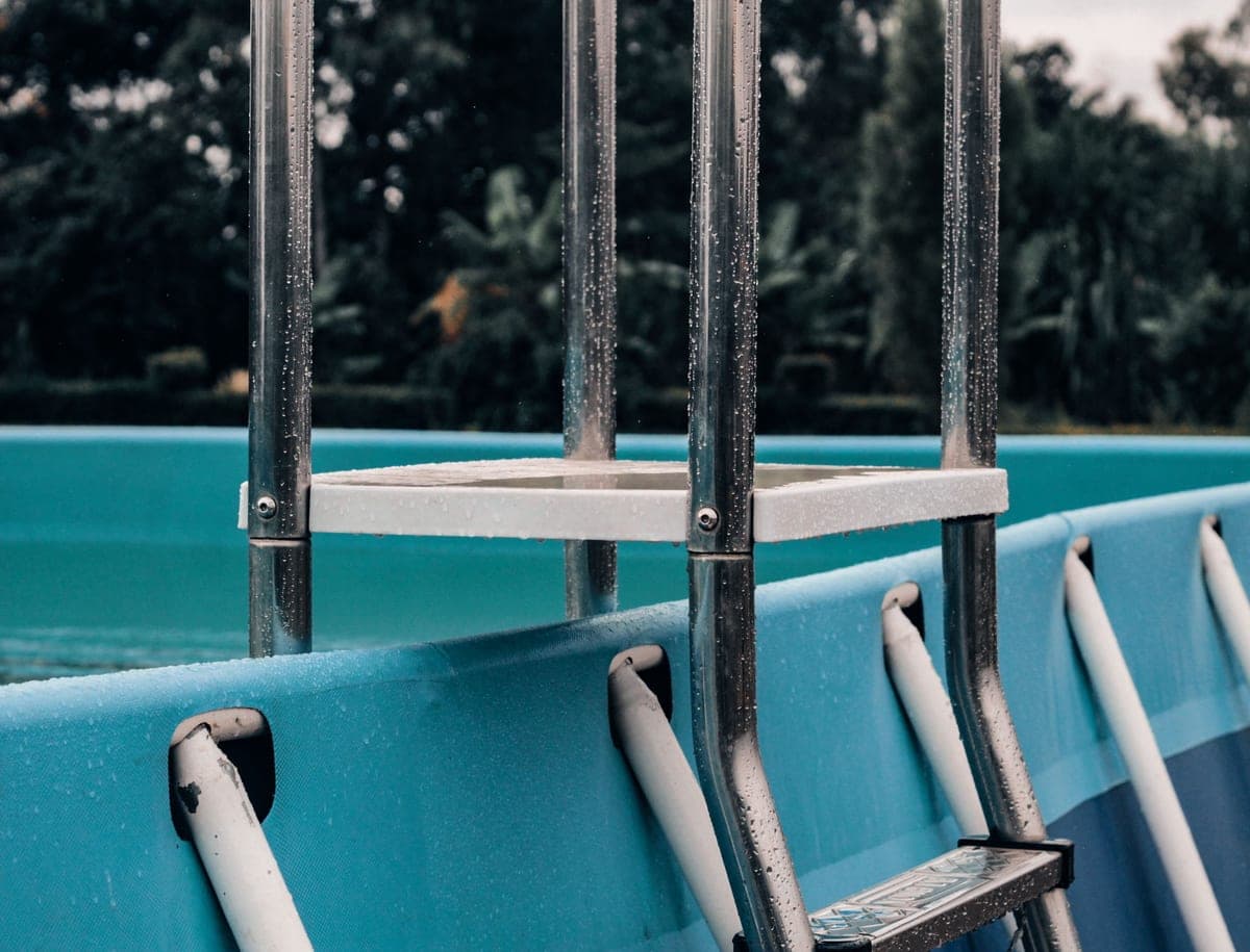 The frame and ladder of a metal-frame above-ground pool