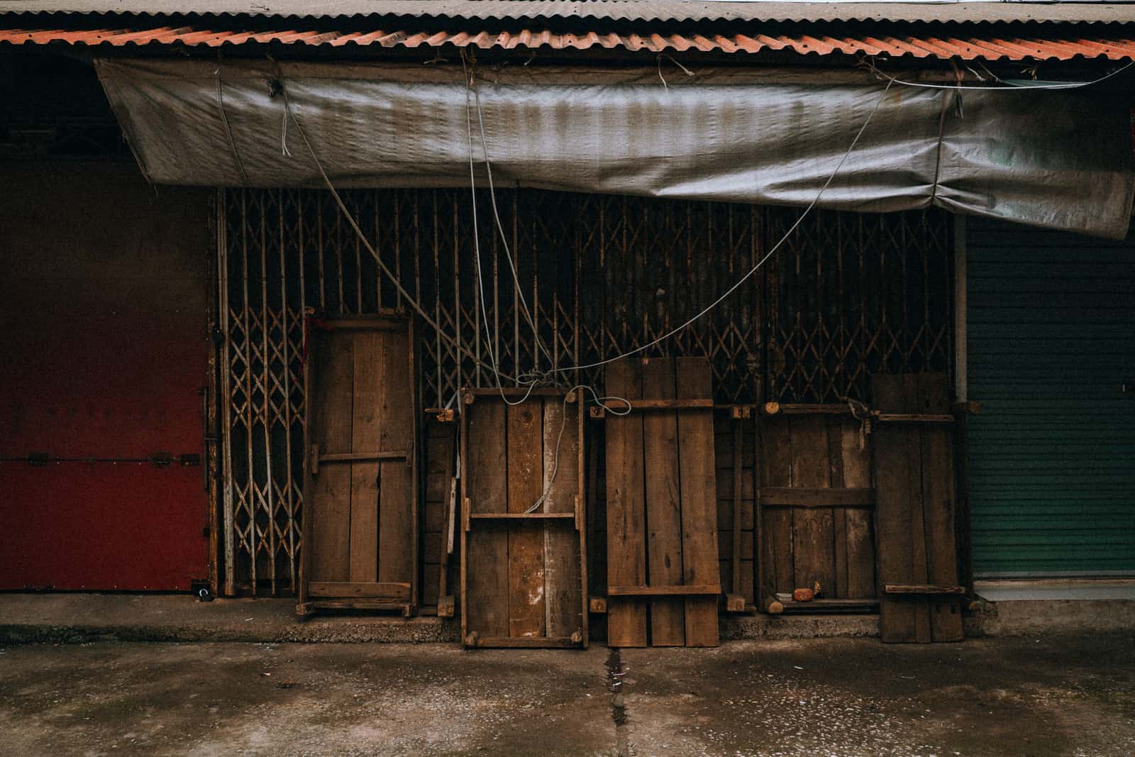 A folded tarpaulin stored on a shelf in a garage