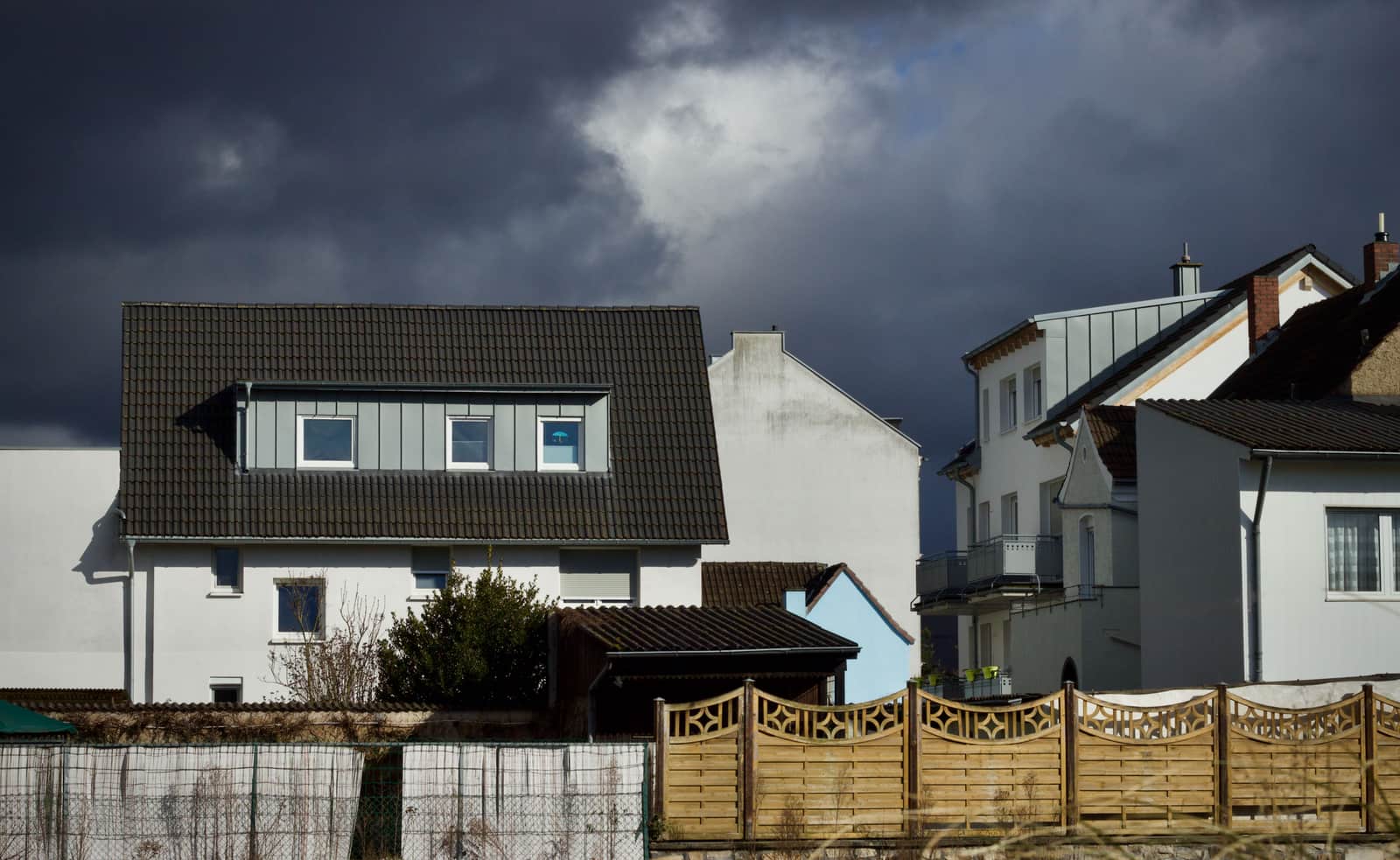 Dark storm clouds gathering over houses