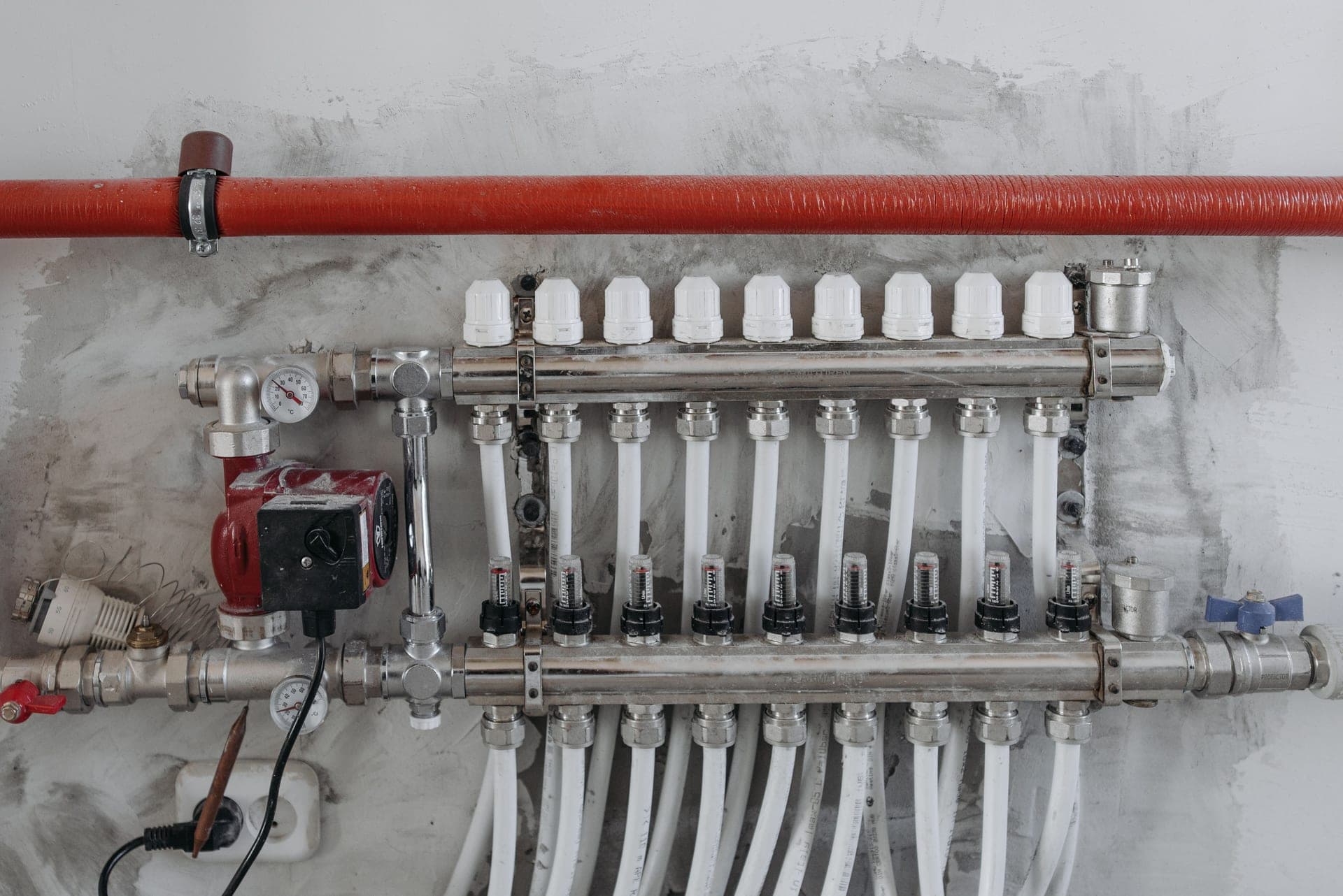 A close-up of a plumbing manifold and steel pipes